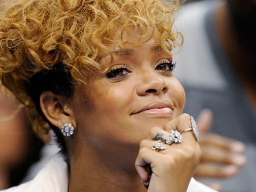 Rihanna attending Grammys alone a year after Chris Brown assault. Brown busy working on Greatist Hits album.